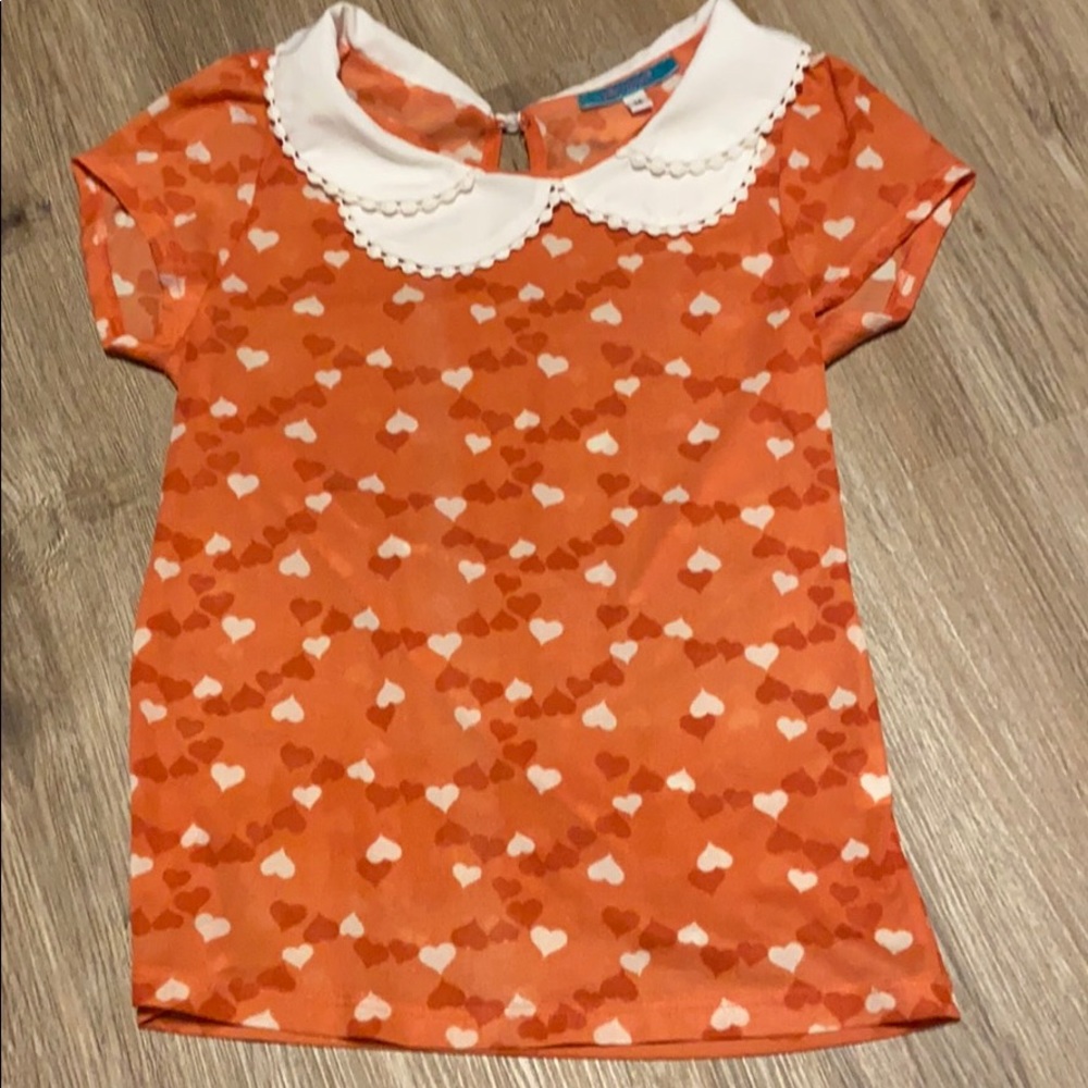 Orange shirt with white collar hearts all over